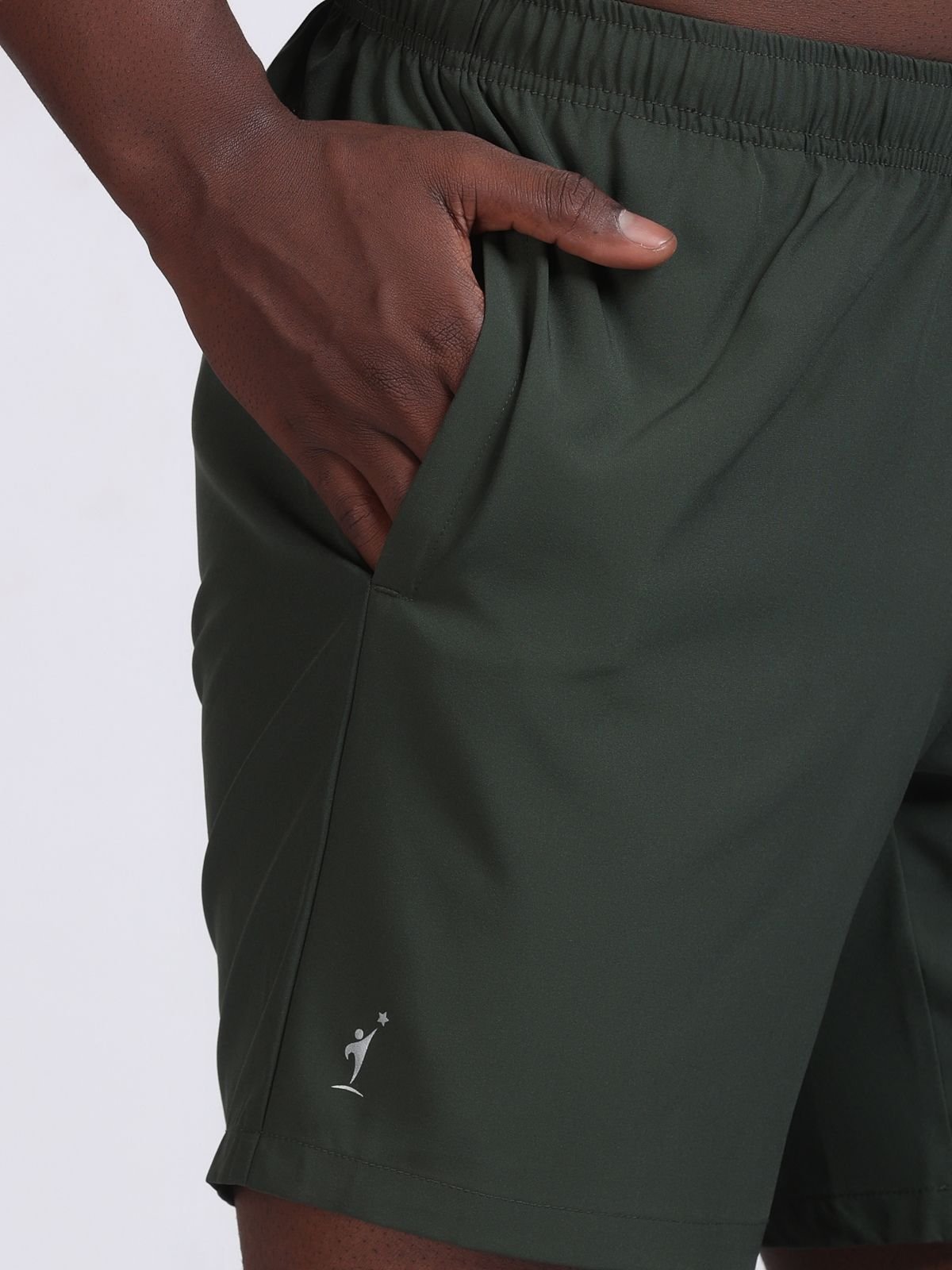 Close-up of the side pocket and logo on olive green athletic Feather LaserTech shorts.