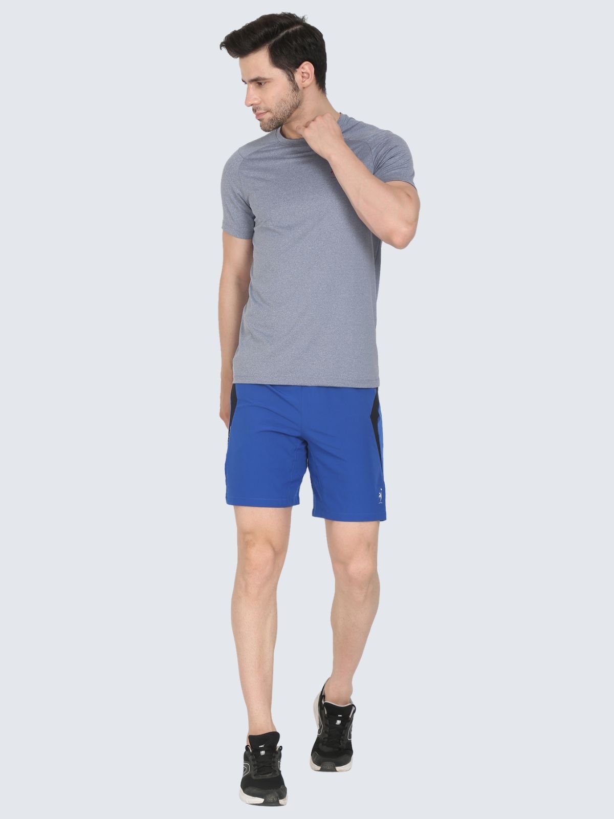 Full-body male model in grey cool n comfort tee wearing royal blue Knitted Mesh athletic shorts on a white background