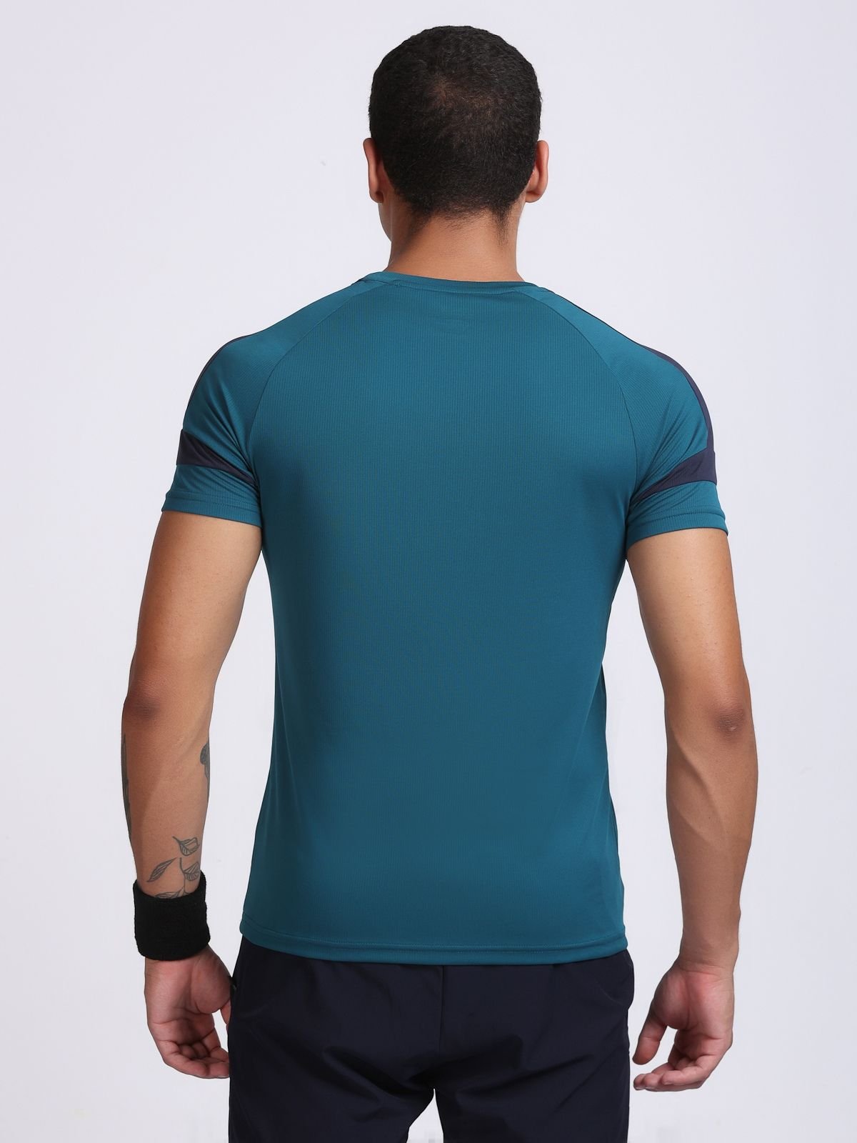 Back view of a man wearing a teal athletic t-shirt AirFeel with navy shoulder panels.