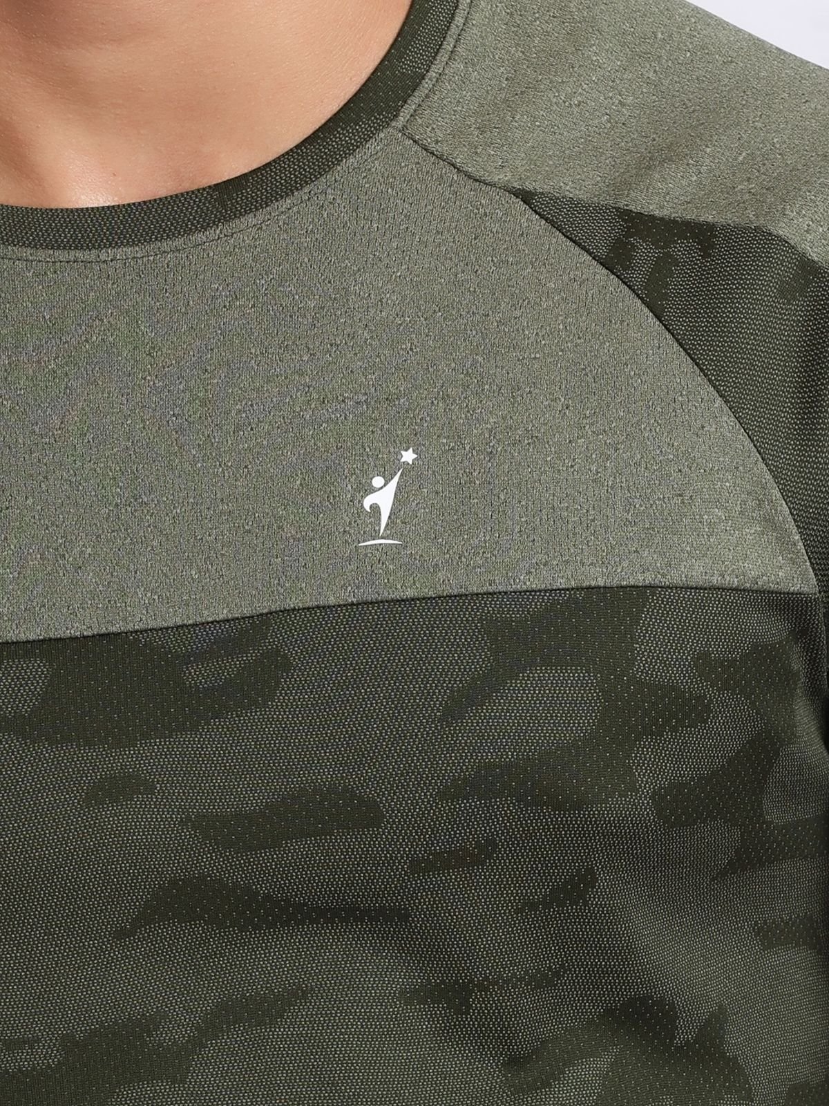Close-up of the chest NDR SPORT logo and camo texture on an olive athletic t-shirt.