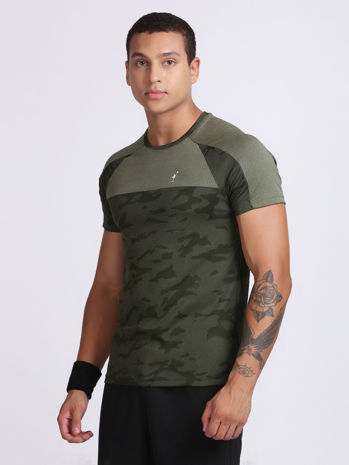 Three-quarter view of a man wearing an olive camo athletic t-shirt.