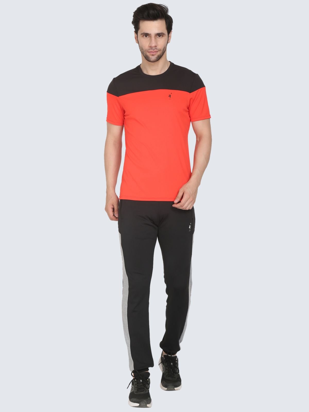 Full-body male model wearing tomato red ClubSpirit T-shirt with black yoke on a white background