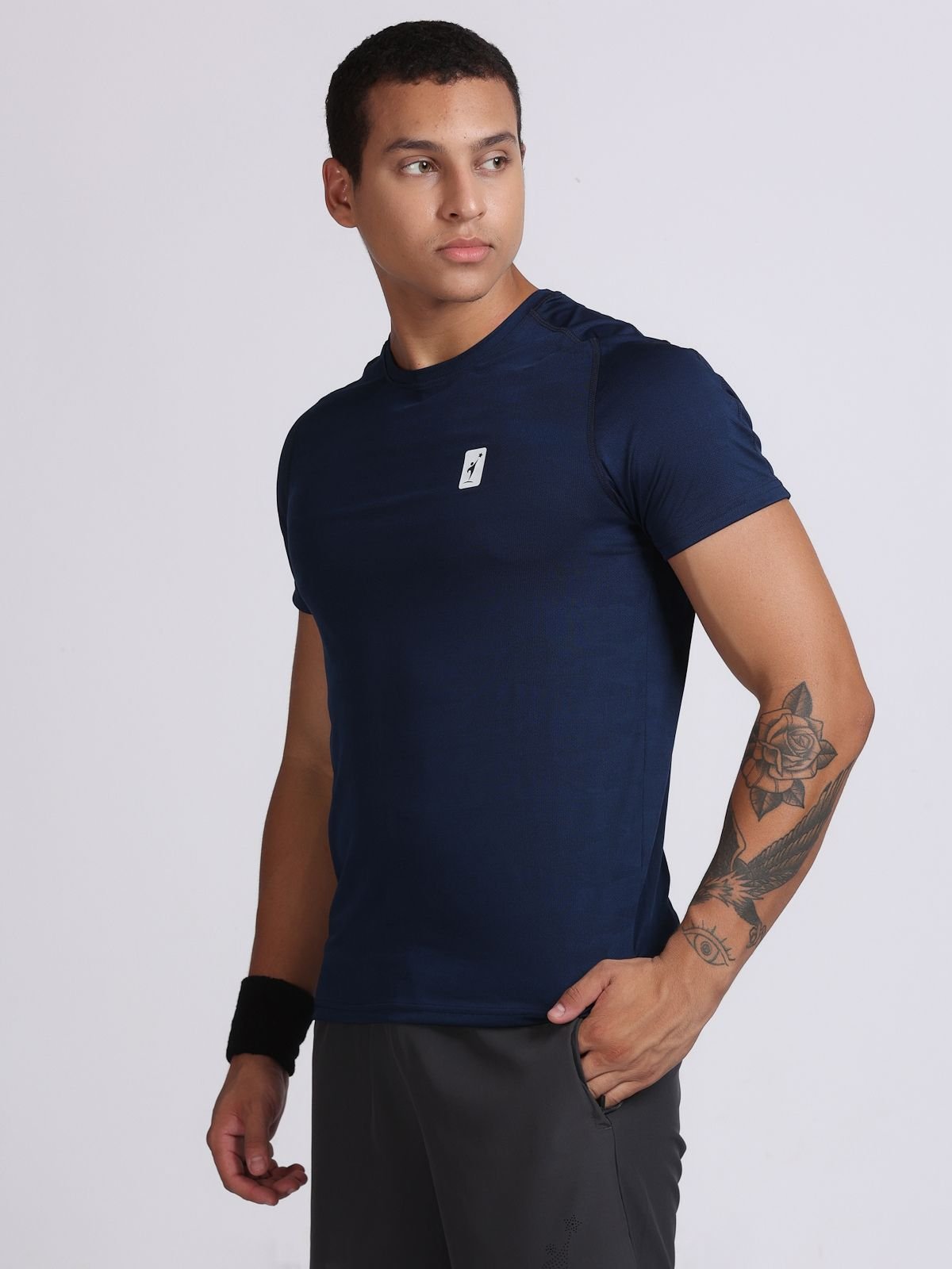 Side view of a man wearing a navy JaqMesh athletic t-shirt.