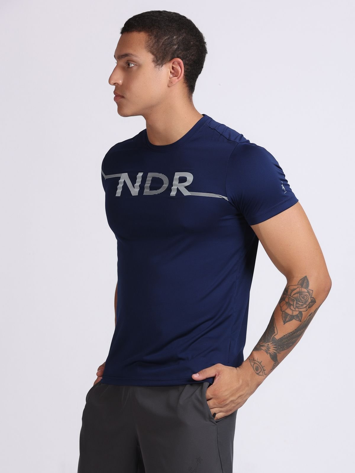 Side view of a man wearing a navy NDR Blitz t-shirt.