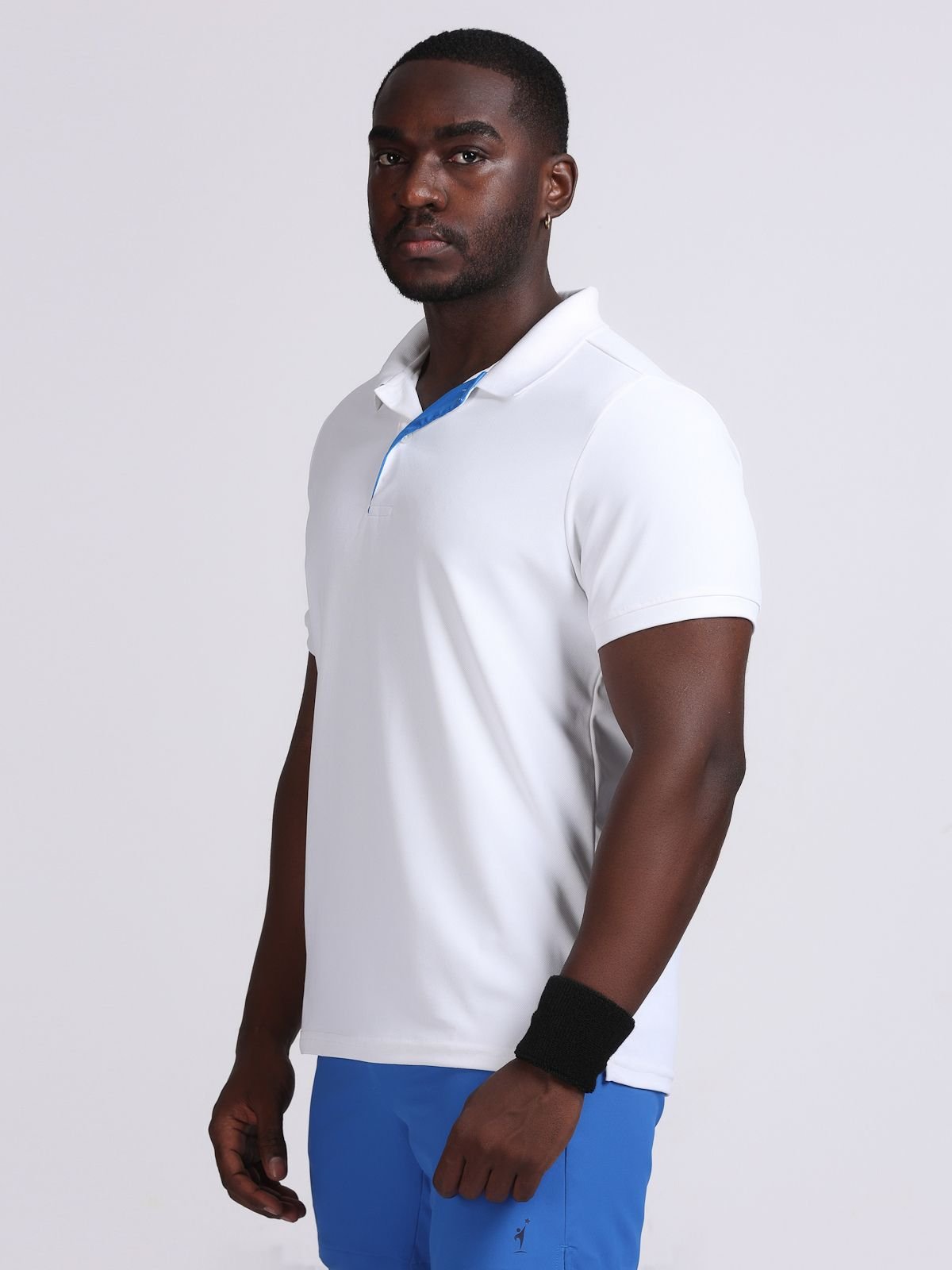 Three-quarter left-side view of a model wearing a white Solid polo t-shirt with bright blue contrast inner placket for GYM cum office.