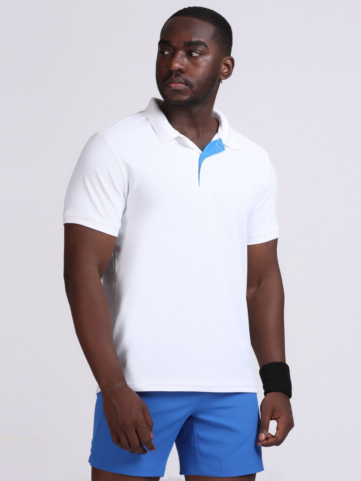 Three-quarter left-side view of a model wearing a white Solid polo t-shirt with bright blue contrast inner placket.