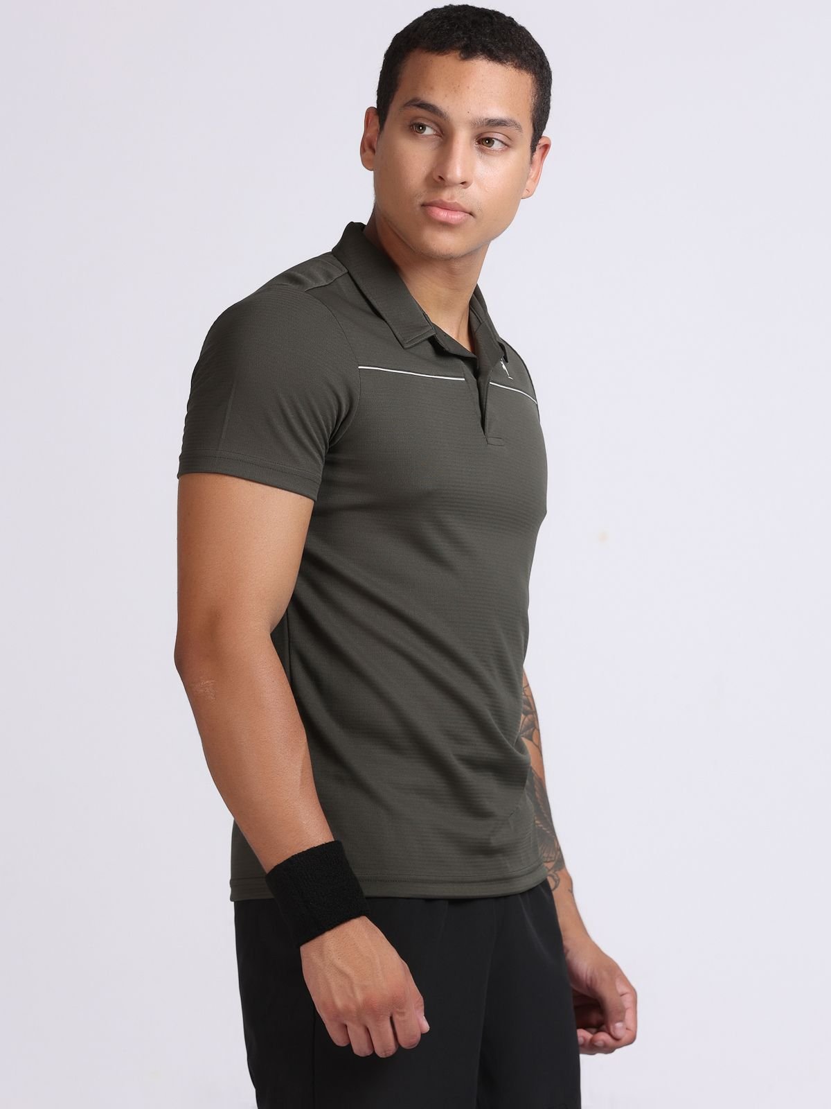 Male model wearing olive green sport polo, right-facing view