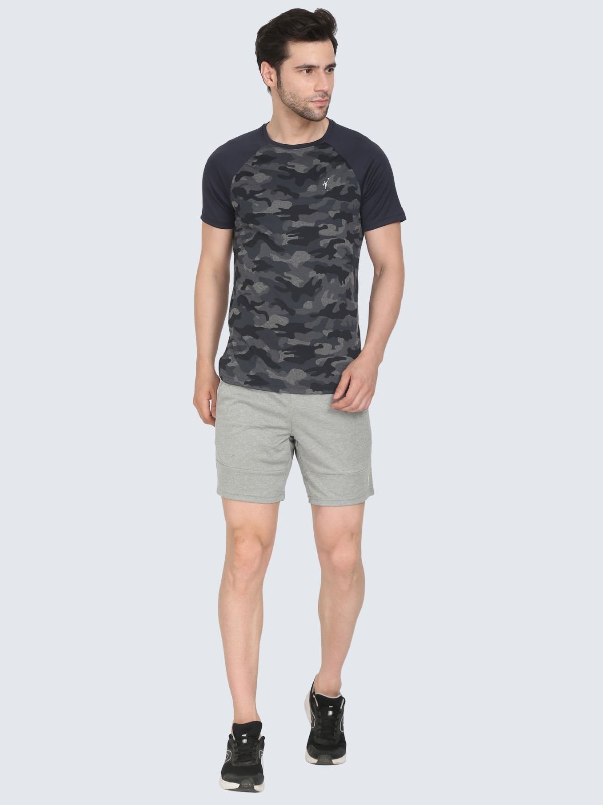 Full-body male model in grey Camo Reglan shoulder tee wearing heather grey Reversible shorts on a white background