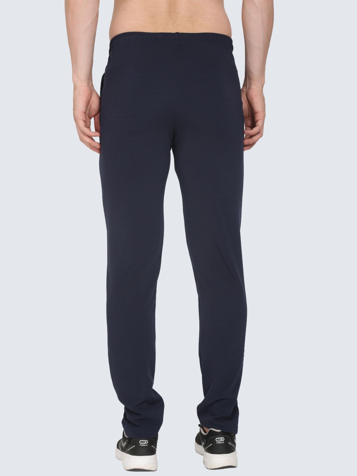 Back view of navy regular stretch athletic pants from waist to ankles on a white background